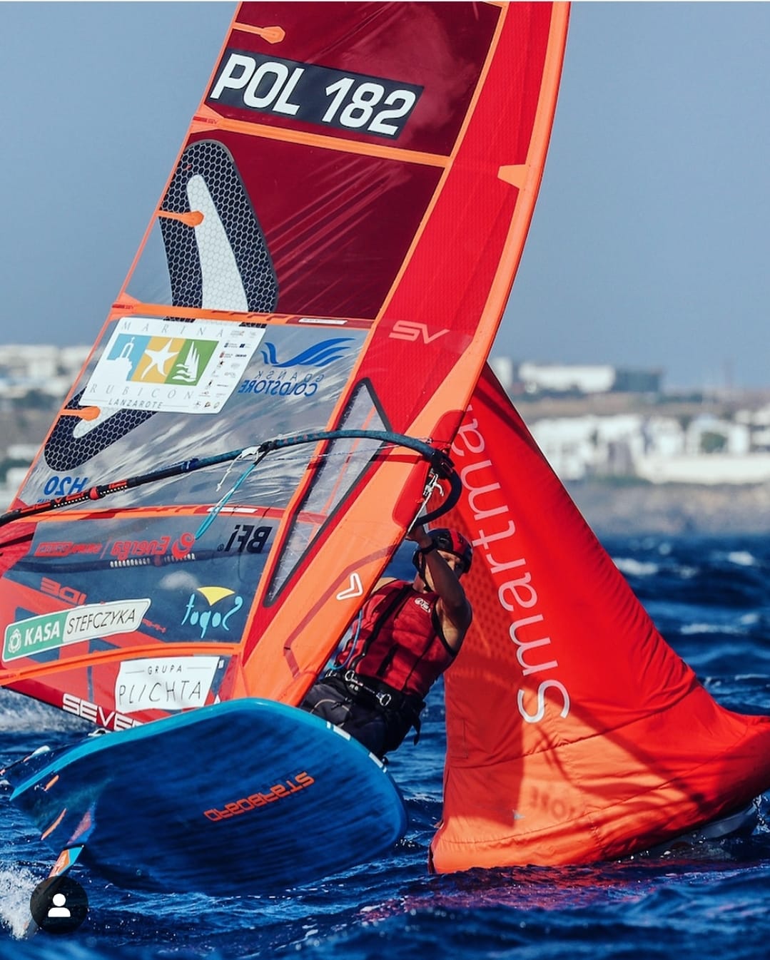 Windsurfer carving across the water